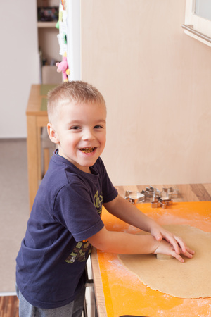 Cute, little boy helps when baking Christmas cookies. Christmas traditions. (Shallow DOF).の写真素材