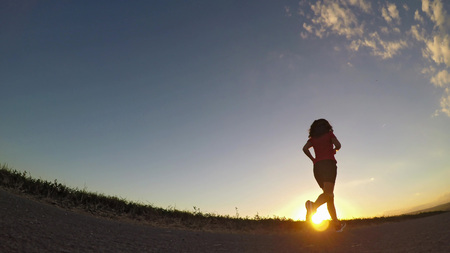 Young woman exercising in summer afternoon.の写真素材