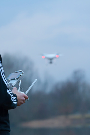The man controls the dron with the camera. (Shallow DOF)