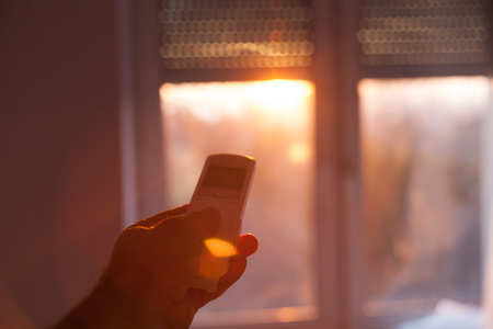 Remote-controlled window blinds in a clever household. Modern living. Shallow DOF; color toned...