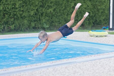 Boy jumping into the water. 