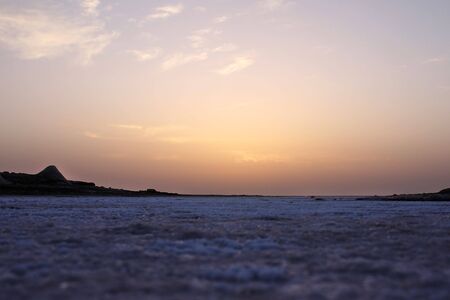 Sunrise in the desert of salt, close-up view of the salt crystalsの写真素材