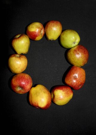 Colorful fresh apples letter alphabet photographed against a black background. - Imageの写真素材