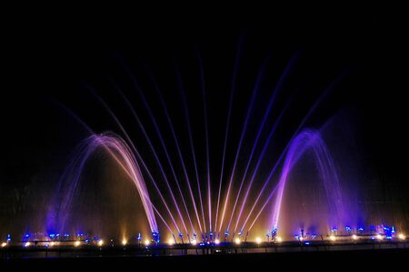 Musical fountain with colorful illuminations at nightの写真素材