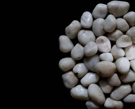 white royal sapphire rock pebbles stock photographed against a black background. - Imageの写真素材