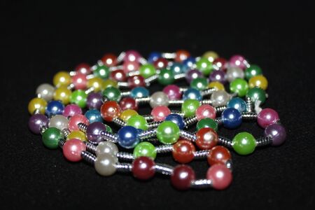 colorful Pearl strings abstract, background row of pearl ornaments on black background- Imageの写真素材
