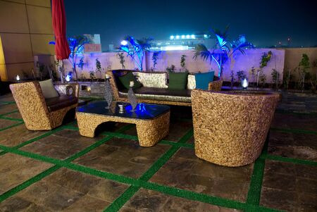 Romantic candle light private dinner, party setup in a restaurant with sofa table and furniture in nightの写真素材