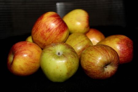 group of Colorful fruit pattern of fresh apples on black background- imageの写真素材