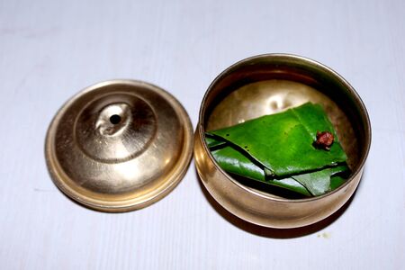 Indian Mouth Freshener Sweet Paan, betel nut leaf served in vintage brass bowl with indian traditional patternの写真素材