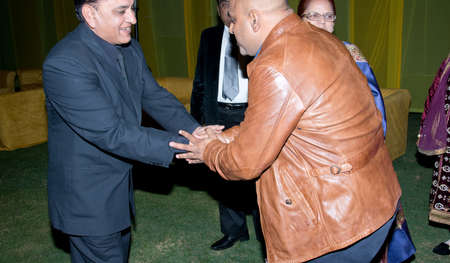 Meeting of old friends without head, successful Indian man meet in night party after years of separation in Indiaのeditorial素材