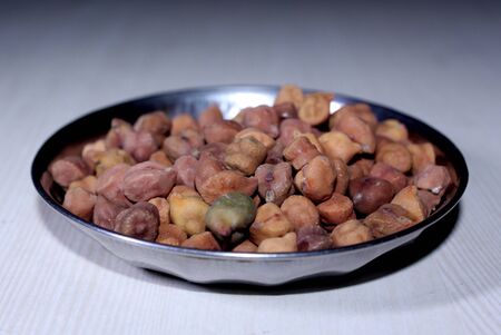 traditional protein nutrition, fresh high fiber grain soaked gram on white wooden backgroundの写真素材