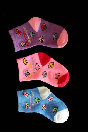 Collection of colorful baby socks, pair of cute baby socks isolated on back backgroundの写真素材