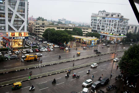 Top view of a developed city road traffic with vehicle, Indian town with business and financial...