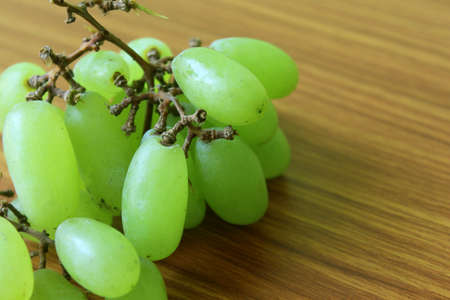 Fresh Grapes Fruits, Natural Healthy berry food put on wooden table, selective focus with blur.の写真素材