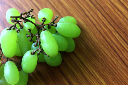 Fresh Grapes Fruits, Natural Healthy berry food put on wooden table, selective focus with blur.の写真素材