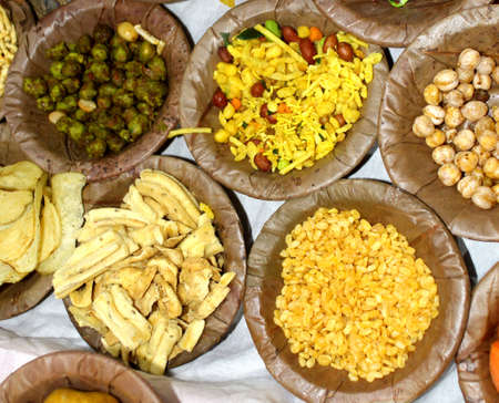 Traditional Indian Festive food and sweets serve in Bio degradable Disposable Palash (Butea Monosperma) Leaf Bowl and Dona with Indian Culture, Assorted Indian dishes, snacks selective focus with blurの写真素材