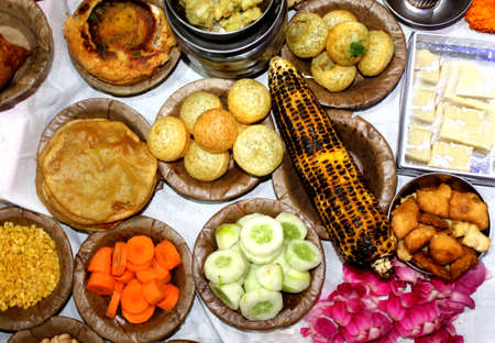 Traditional Indian Festive food and sweets serve in Bio degradable Disposable Palash (Butea Monosperma) Leaf Bowl and Dona with Indian Culture, Assorted Indian dishes, snacks selective focus with blurの写真素材