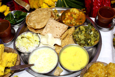 Traditional Indian Festive food and sweets serve in Bio degradable Disposable Palash (Butea Monosperma) Leaf Bowl and Dona with Indian Culture, Assorted Indian dishes, snacks selective focus with blurの写真素材