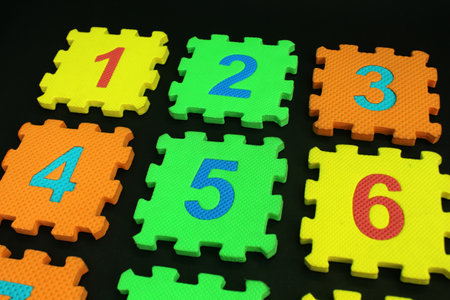 Colorful number puzzle isolated on black background. Number learning block for children education.の写真素材