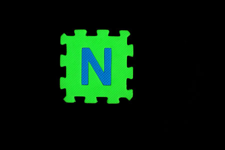 Colorful alphabet puzzle isolated on black background. alphabet learning block for children education.の写真素材