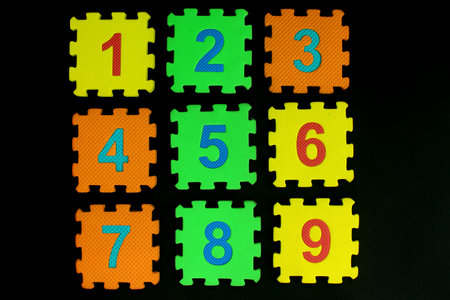 Colorful number puzzle isolated on black background. Number learning block for children education.の写真素材
