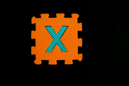 Colorful alphabet puzzle isolated on black background. alphabet learning block for children education.の写真素材