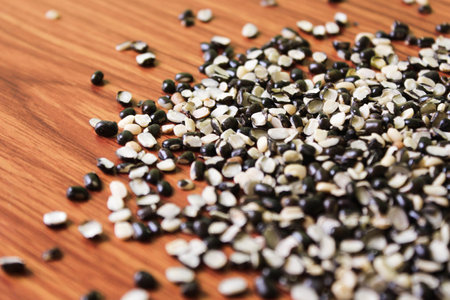 Split Black Lentil Also Know as Black Gram, Black Urad Dal, Vigna Mungo, Urad Bean on brown wooden...