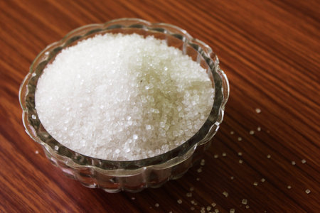 White sugar in bowl on wood background.selective focus with blurの写真素材
