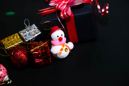 Christmas ornaments and gifts on a black background with copy space