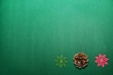 Season's greetings scene. gift boxes tied with bows, Christmas decorations, balls, rustic star, holly berries, frosty spruce branches, confetti on green backdrop, perfect for messages or promo, selective focus with blurの写真素材