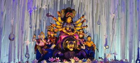 Colorful and intricately designed Durga Puja pandal with a large idol of Goddess Durga ,The scene...