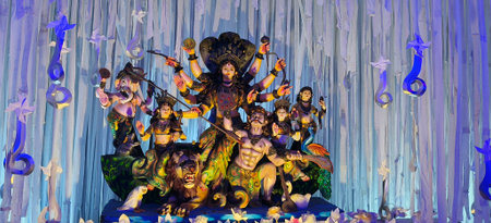 Colorful and intricately designed Durga Puja pandal with a large idol of Goddess Durga ,The scene...