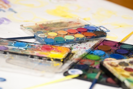 several used watercolor paint set with brushesの写真素材