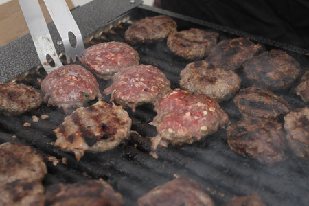 Fresh meatballs grilled outdoors on a gas grill. Barbecueの写真素材