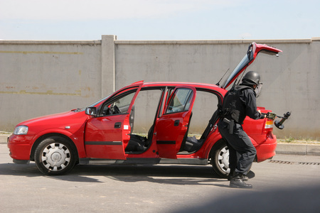 Police squad disarm a bomb inside a car of terrorists during military training in the city of Sofia, Bulgaria on Sep,11, 2007. Bomb squad robotのeditorial素材