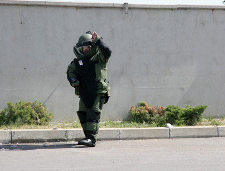 Police squad disarm a bomb inside a car of terrorists during military training in the city of Sofia, Bulgaria on Sep,11, 2007. Bomb squad robotのeditorial素材