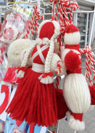 Red and white Martenitsi on outdoor market for martenici. Martenitsa or martenitza is given on 1st March as a symbol of health and prosperity. Red and white threads for health.の写真素材