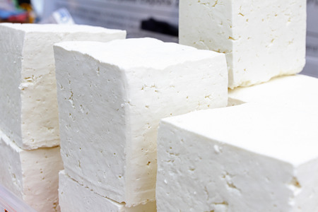 White brine cheese from cow, goat or sheep milk ready for eating . White brine bulgarian sirene ready for consummation. Traditional cheese from Balkans. Cubes of Bulgarian sirene white brine cheeseの写真素材