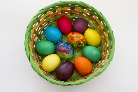 Easter eggs. Handmade painted eggs in basket for Easter celebration isolated on white background....