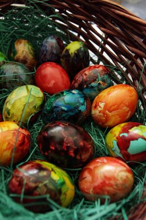 Easter eggs. Handmade painted eggs in basket for Easter celebration with art light. Easter. Colored Easter eggs. Colorful egg. Copy space. Text space. Unique handmade painted eggsの写真素材
