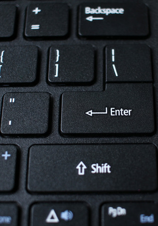 Enter button on laptop keyboard. Enter keyboard key button on a computer. Close up of Enter key of...