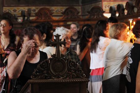 Woman make the sign of the cross and pray in church in Sofia, Bulgaria on july 27, 2012.のeditorial素材
