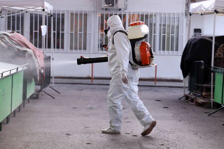 Disinfection and decontamination on a public place as a prevention against Coronavirus disease 2019, COVID-19.の写真素材