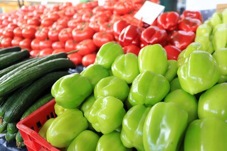 Red and green peppers and vegetables on a farmer market.の写真素材