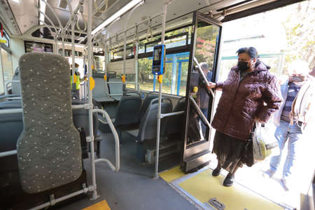 People are wearing protective mask while traveling by public transport (bus) in Sofia, Bulgaria on Nov 01, 2021のeditorial素材