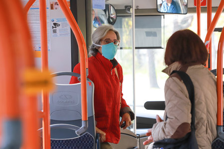 People are wearing protective mask while traveling by public transport (bus) in Sofia, Bulgaria on Nov 01, 2021のeditorial素材