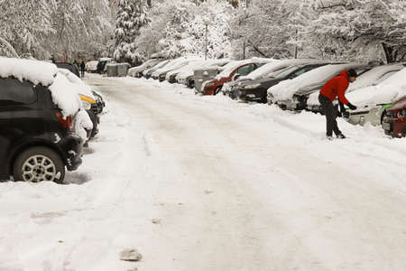 People clean snow from cars after snowfall in Sofia, Bulgaria on Jan 21, 2022の写真素材