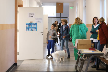 People in front of voting sections for elections of Bulgarian parliament in Sofia, Bulgaria on 10/02/2022のeditorial素材