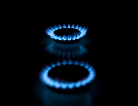 Two gas stove burners with blue flames. Illustration of traditional energy sources.  Shallow depth-of-field.の写真素材