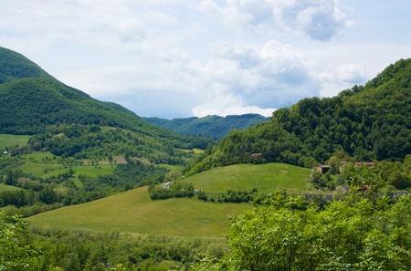 Mountain landscape with farmhouses and fields near Bologna (Emilia-Romagna) の写真素材